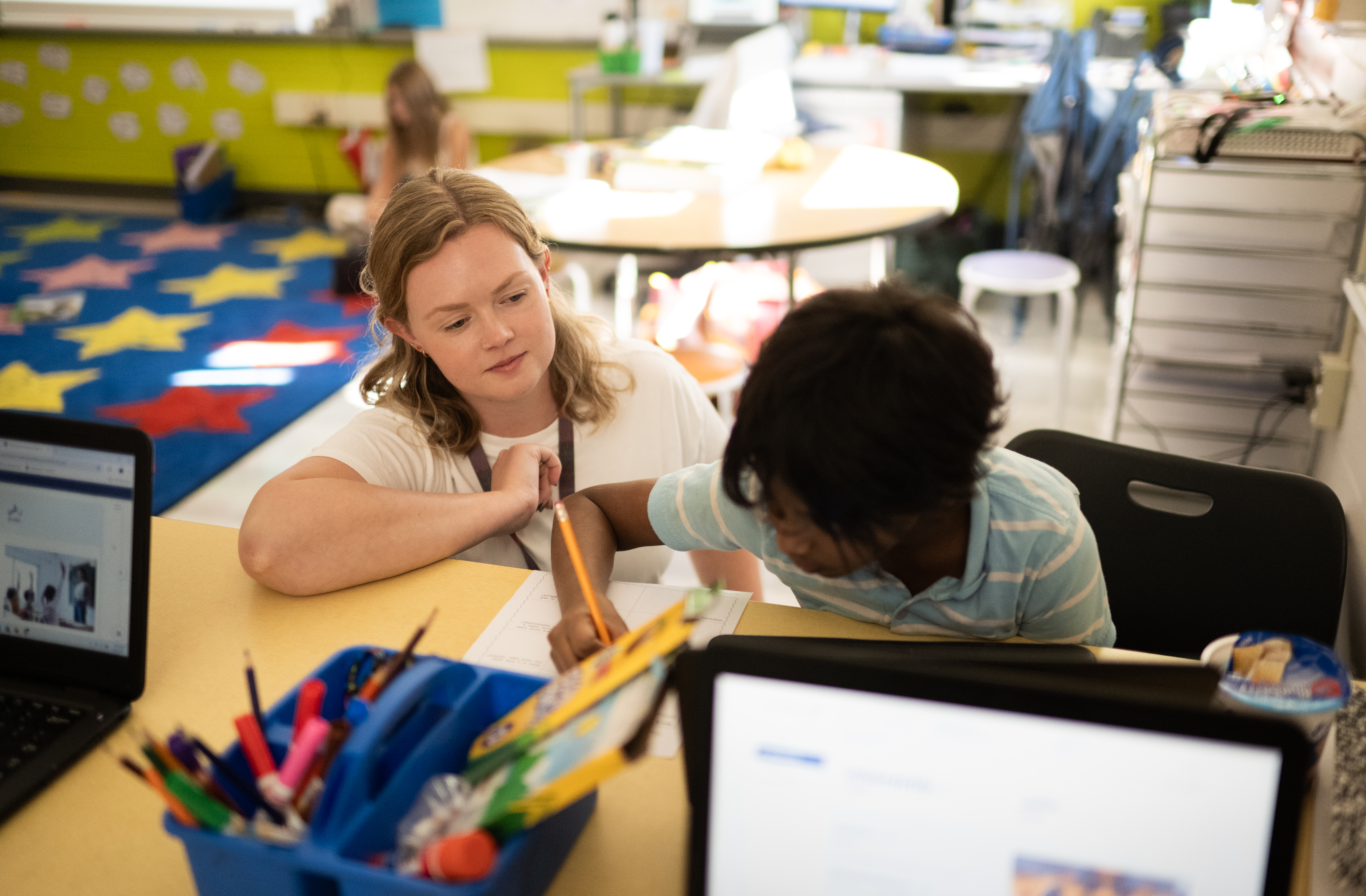 teacher helping student